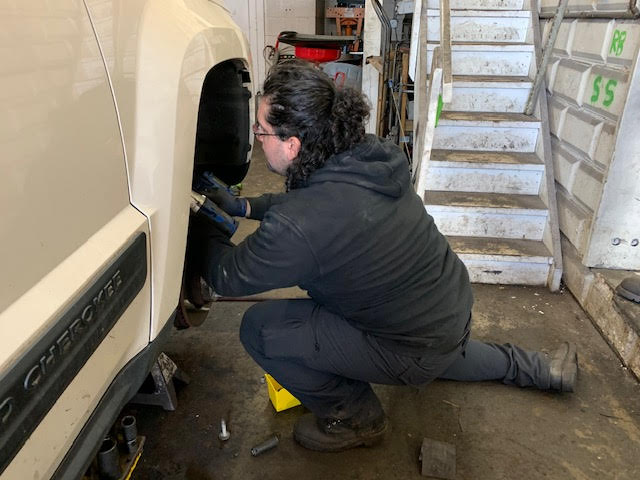 Sebastian Sanchez working on a vehicle